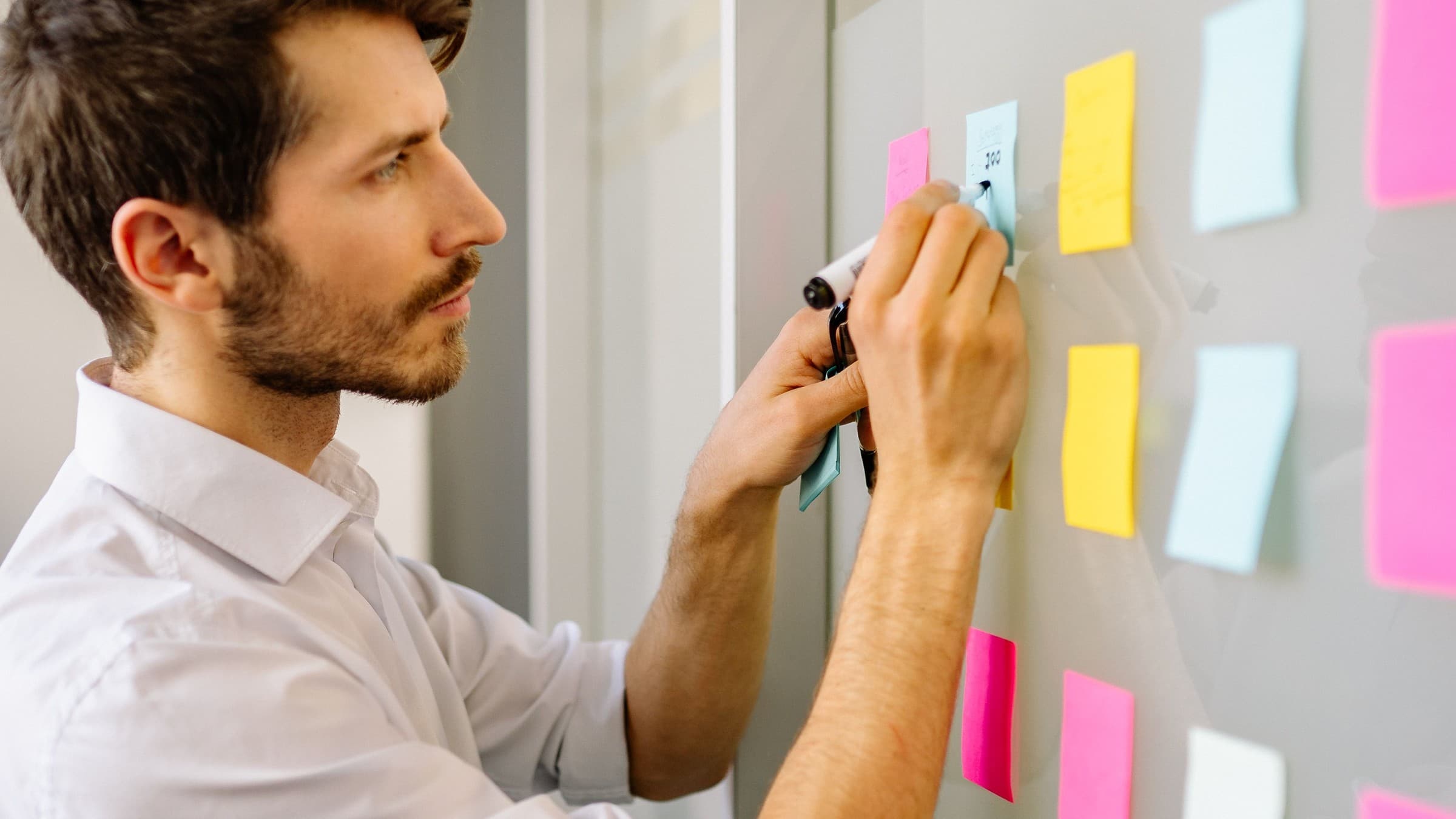 Founder organizing a target-account list on an office planning wall