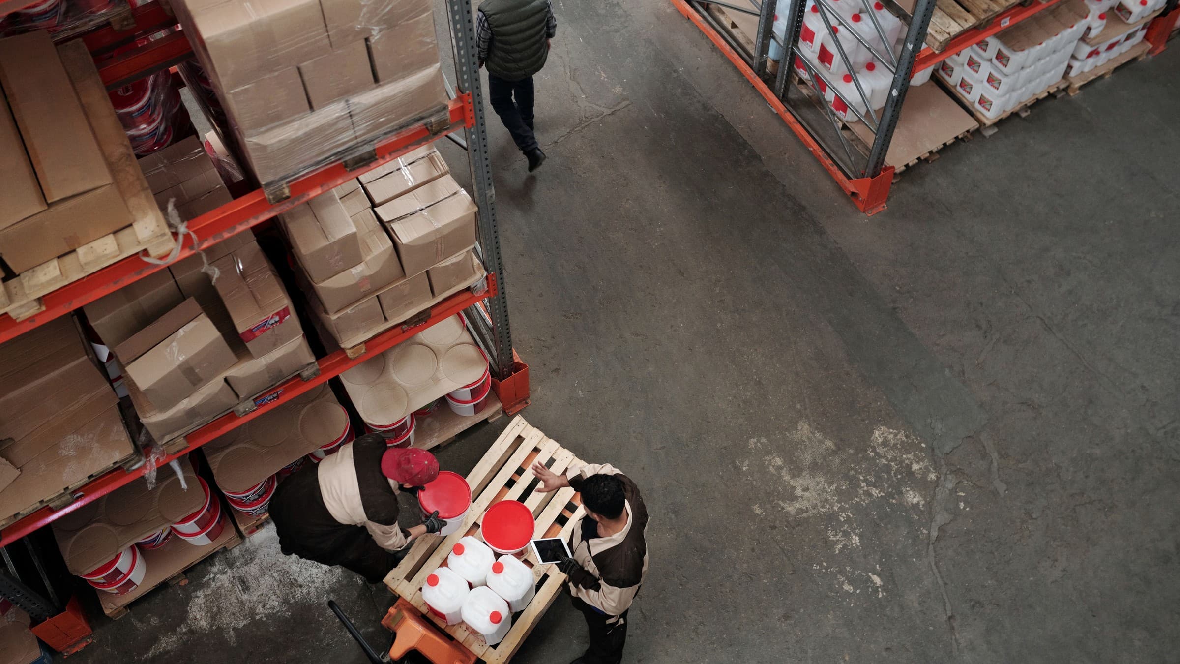 Distributor checking labeled cartons during a supplier warehouse visit